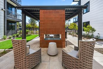 Covered patio with lounge seating and fire pit for relaxation